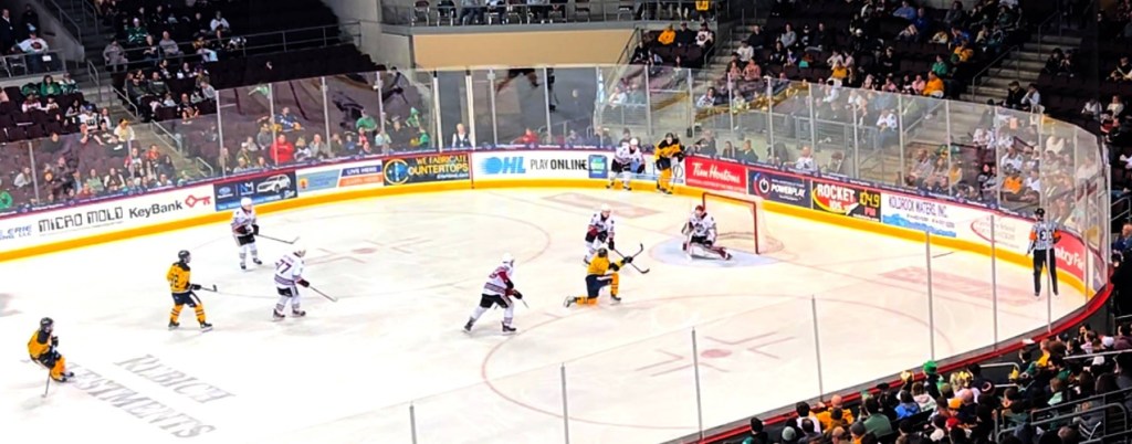Erie Otters forward Malcolm Spence, from his kneeling position, scores against Guelph Storm goaltender Colin Ellsworth during the teams' March 16, 2025, Ontario Hockey League game at Erie Insurance Arena. Spence recorded two goals late in Erie's 6-4 victory.