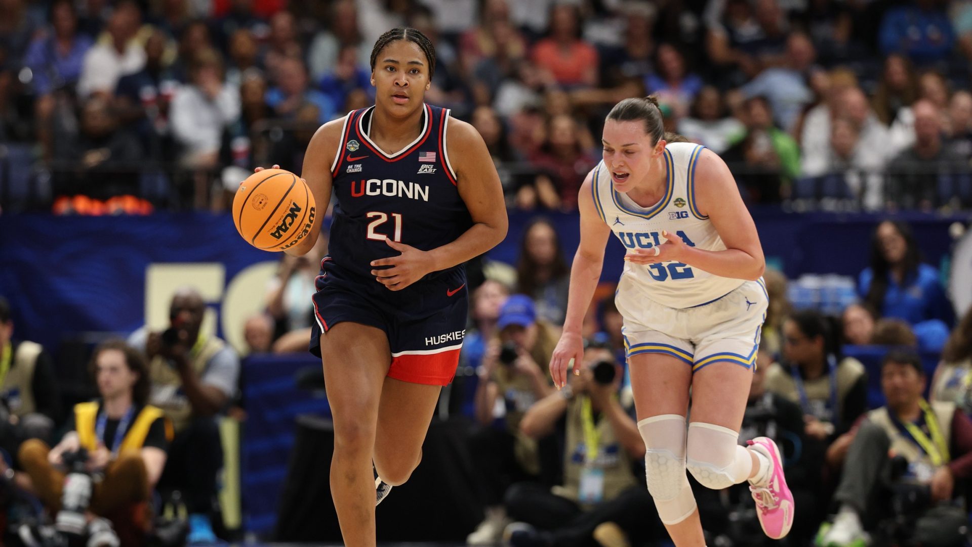 Apr 4, 2025; Tampa, FL, USA; Connecticut Huskies guard KK Arnold (2)1 dribbles against UCLA Bruins forward Angela Dugalic (32) during the third quarter in a semifinal of the women's 2025 NCAA tournament at Amalie Arena.