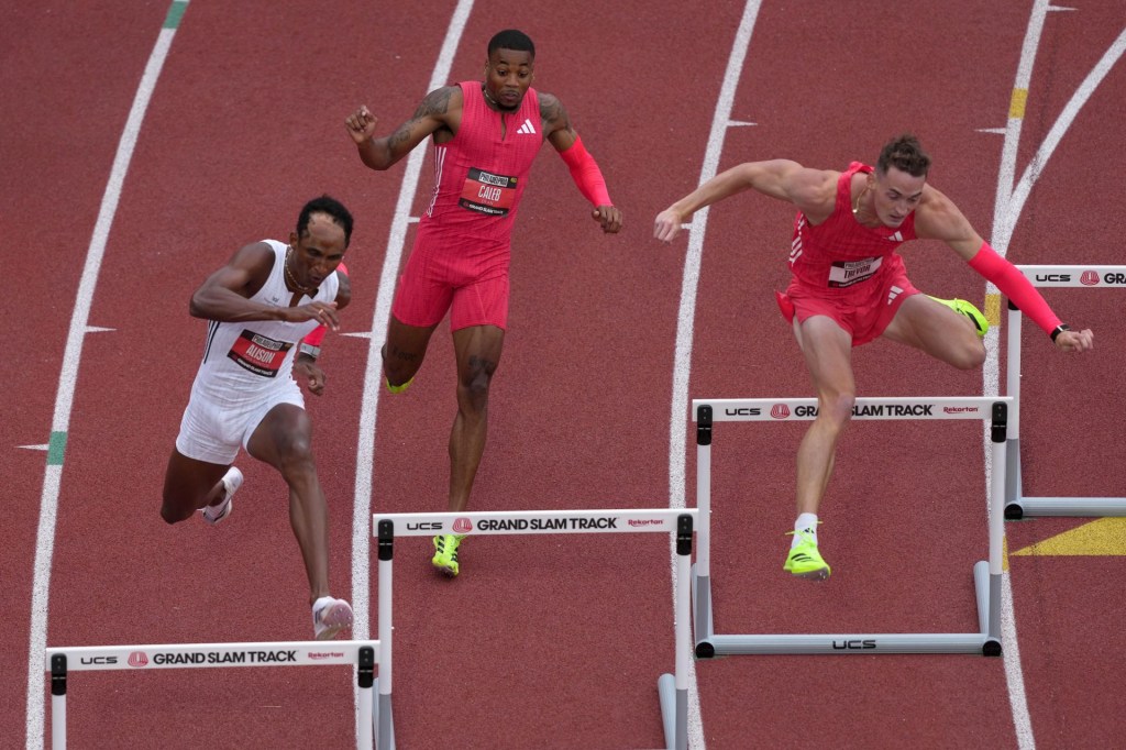 May 31, 2025; Philadelphia, PA, USA; Alison Dos Santos (BRA), left, Caleb Dean (USA), center, and Trevor Bassitt (USA) run in the 400m hurdles during the Grand Slam Track Philadelphia at Franklin Field