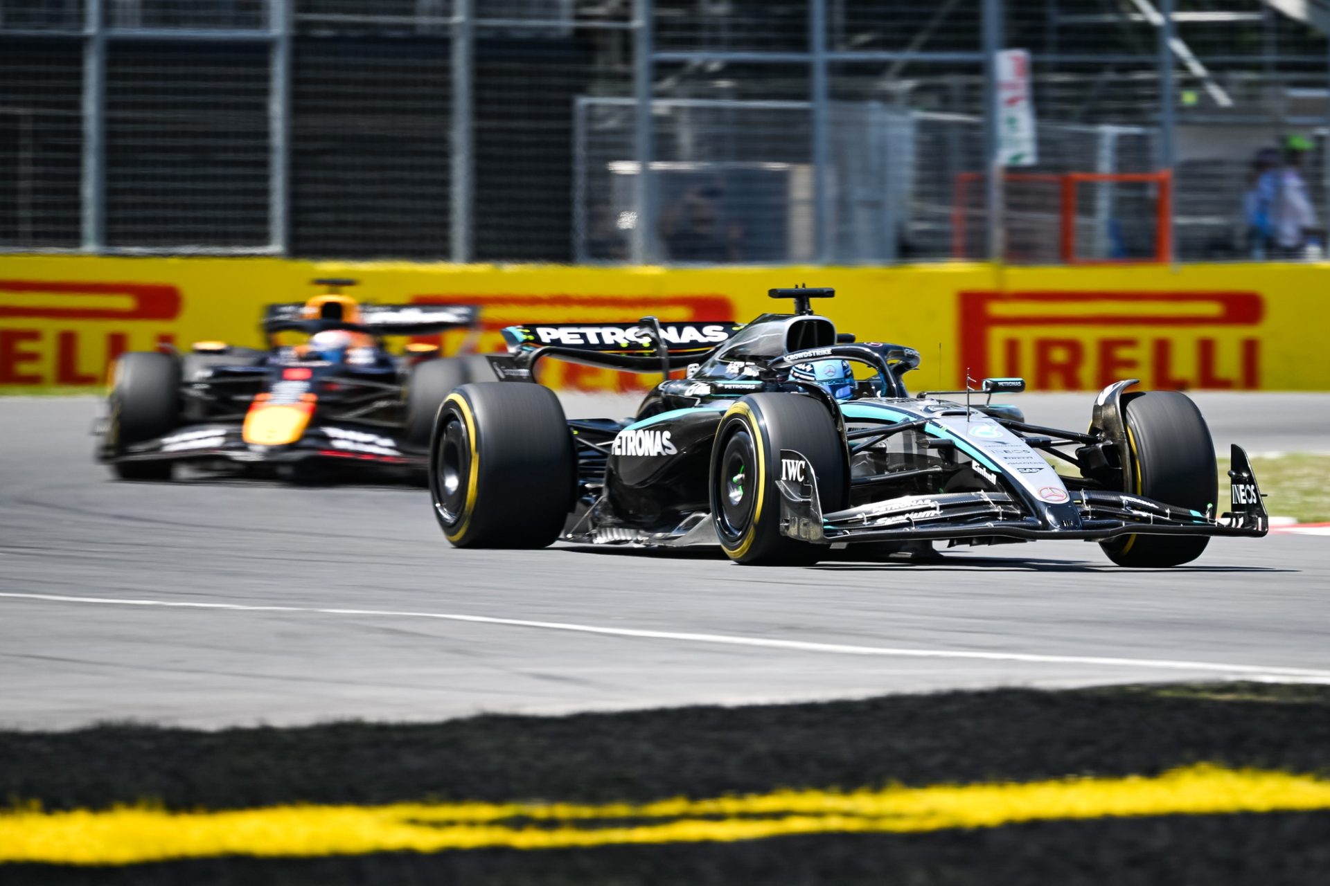 Jun 15, 2025; Montreal, Quebec, Canada; Mercedes driver George Russell (63) leads the second lap over Red Bull Racing driver Max Verstappen (1) during the F1 Canadian Grand Prix at Circuit Gilles-Villeneuve.