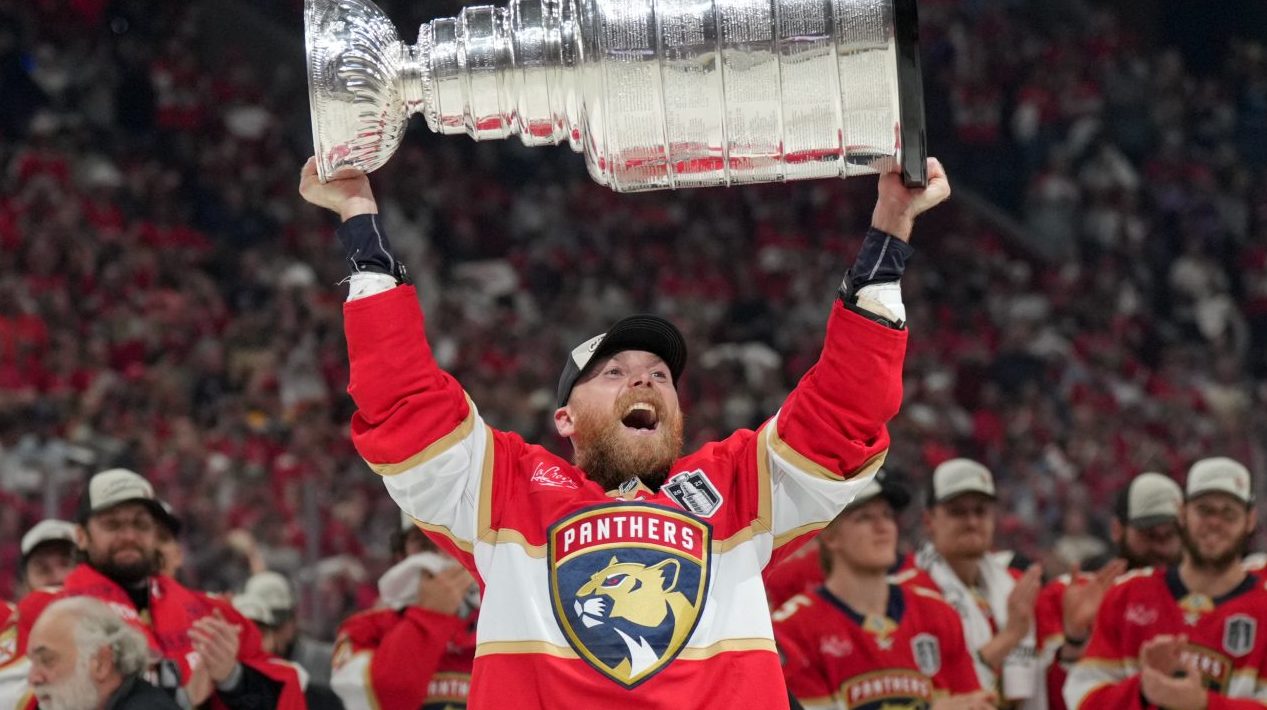 Jun 17, 2025; Sunrise, Florida, USA; Florida Panthers center Sam Bennett (9) hoists the Stanley Cup after winning game six of the 2025 Stanley Cup Final against the Edmonton Oilers at Amerant Bank Arena
