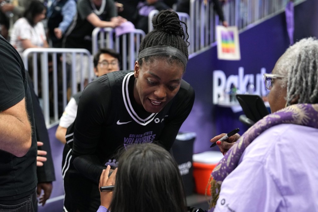 Jun 29, 2025; San Francisco, California, USA; Golden State Valkyries center Temi Fagbenle (center) talks with a fan after the game against the Seattle Storm at Chase Center.