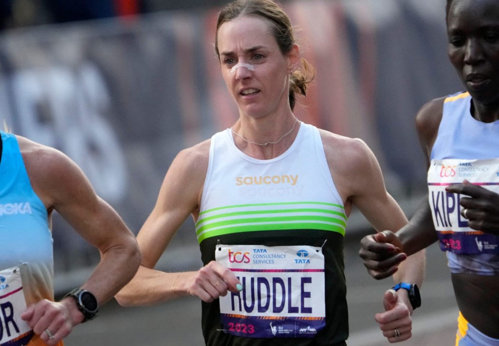 Nov 5, 2023; New York, NY, US; Molly Huddle (USA) is shown on First Ave. with approximately nine miles to go to the finish line. Huddle came in ninth place with a time of 2:32:02