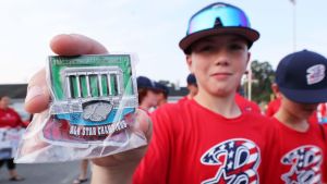 Bridgewater American 12U Little League player Micah Poulter holds a District 7 pin during a send-off rally to the New England regional tournament in Bristol, Connecticut, from Legion Field on Friday, August 2, 2024.