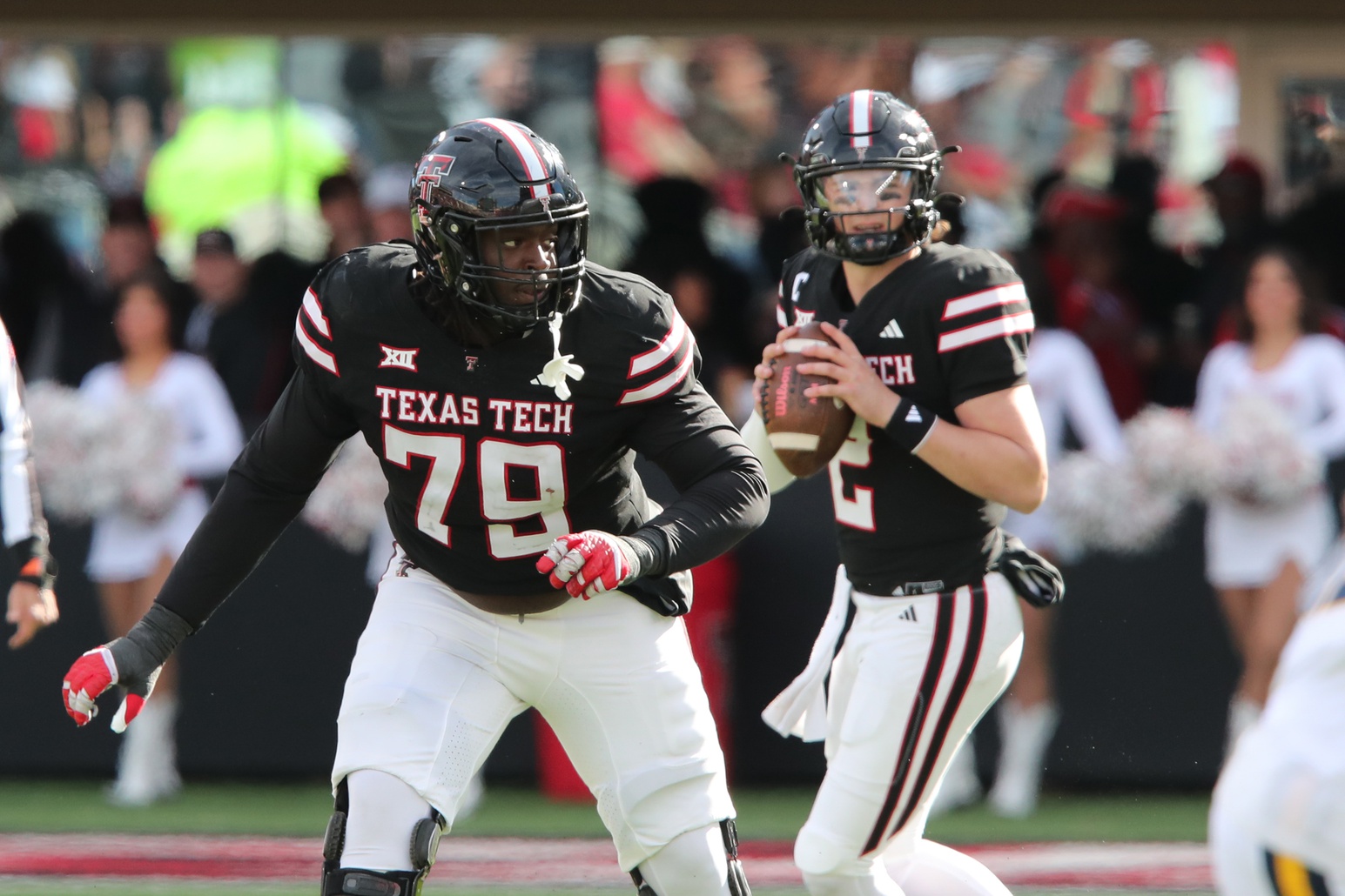 Nov 30, 2024; Lubbock, Texas, USA; Texas Tech Red Raiders offensive guard Sterling Porcher (79) blocks for quarterback Behren Morton (2) in the second half during the game against the West Virginia Mountaineers at Jones AT&T Stadium and Cody Campbell Field.