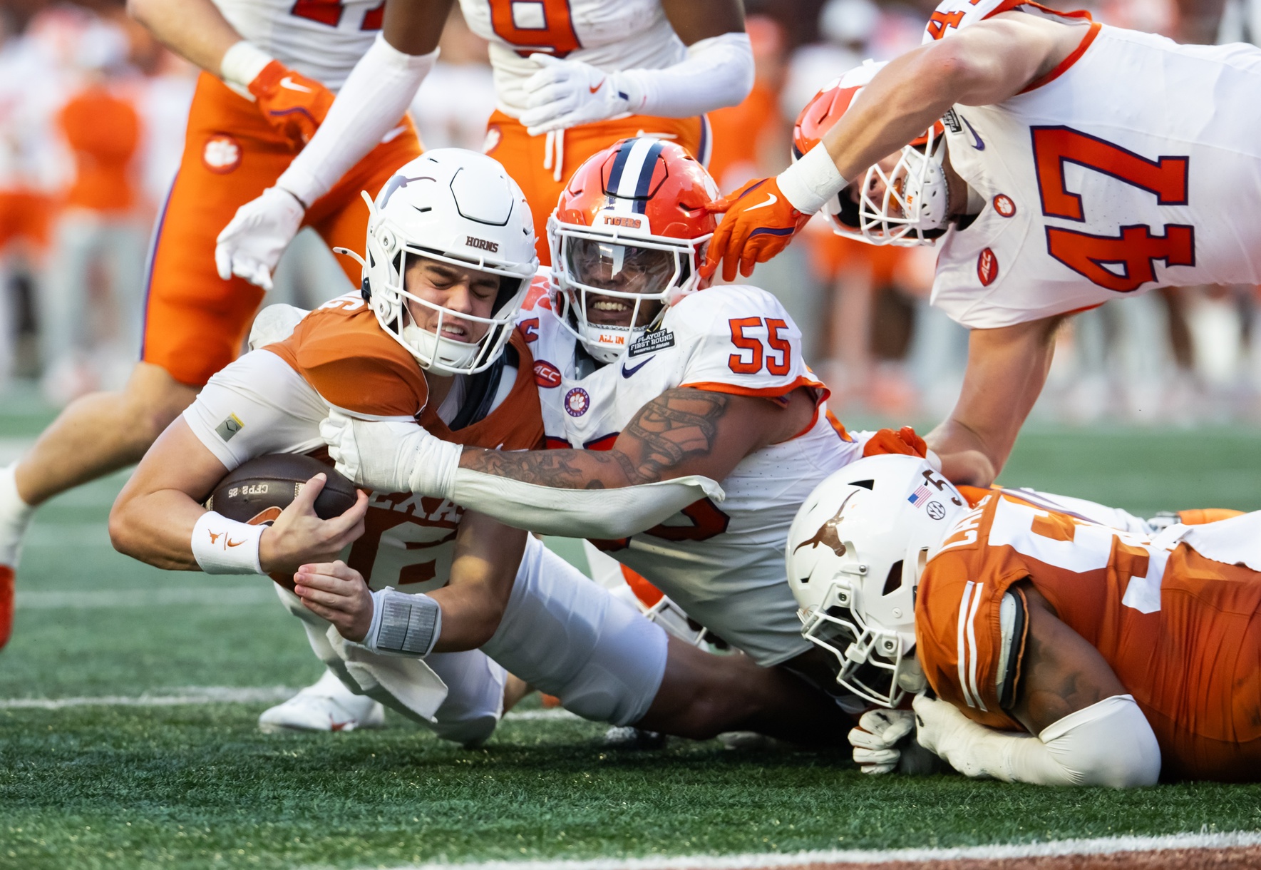 Dec 21, 2024; Austin, Texas, USA; Texas Longhorns quarterback Arch Manning (16) is tackled by Clemson Tigers defensive tackle Payton Page (55) during the second half of the CFP National playoff first round at Darrell K Royal-Texas Memorial Stadium