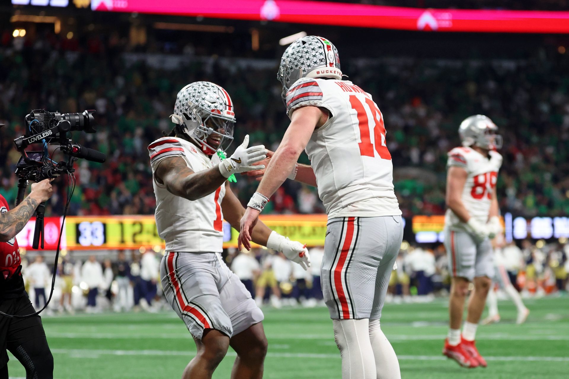 Jan 20, 2025; Atlanta, GA, USA; Ohio State Buckeyes running back Quinshon Judkins (1) and quarterback Will Howard (18) celebrate after a touchdown against the Notre Dame Fighting Irish during the second half the CFP National Championship college football game at Mercedes-Benz Stadium.
