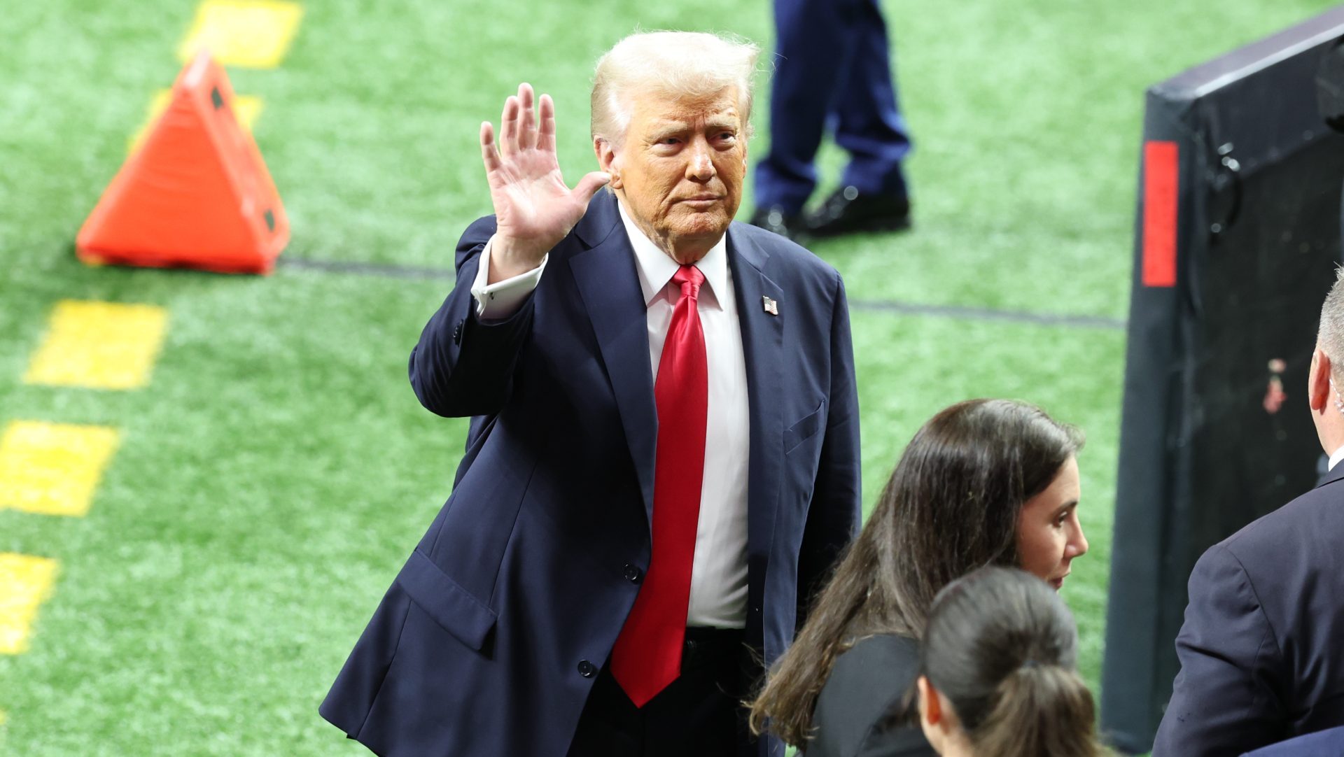 Feb 9, 2025; New Orleans, LA, USA; President Donald Trump leaves the field after participating in a meet and greet with the honorary coin toss participants including family members of the victims from the terrorist attack, members of the New Orleans Police Department, and emergency personnel before Super Bowl LIX between the Philadelphia Eagles and the Kansas City Chiefs at Ceasars Superdome.