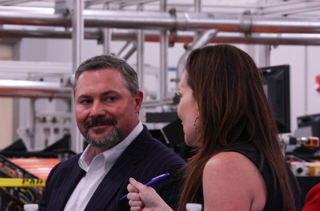 Texas Tech University System Board of Regents Chairman Cody Campbell listens to U.S. Department of Agriculture Secretary Brooke Rollins speak to other Texas Tech leaders at the USDA Agricultural Marketing Service Cotton Classification Complex on April 16, 2025