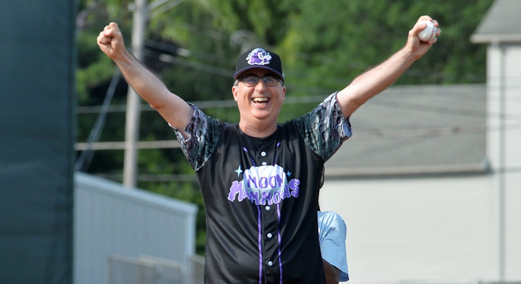 John Oliver, host of HBO show Last Week Tonight with John Oliver throws out the first pitch during the first of four promotional baseball games in Erie on July 19, 2025. The Erie SeaWolves, a Double-A Minor League Baseball team affiliate of the Detroit Tigers, are temporarily rebranding as the Erie Moon Mammoths for four games this year as part of a promotional collaboration with HBOs Last Week Tonight with John Oliver