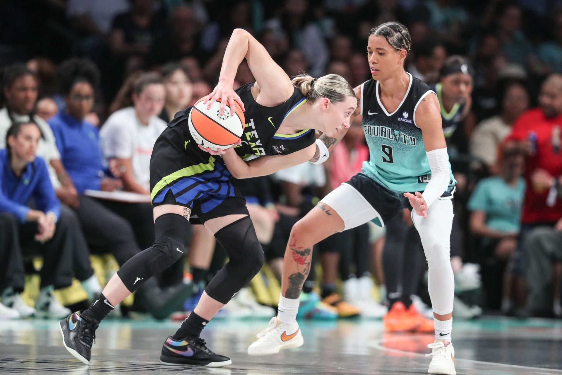 Aug 5, 2025; Brooklyn, New York, USA; Dallas Wings guard Paige Bueckers (5) looks to drive past New York Liberty guard Natasha Cloud (9) in the third quarter at Barclays Center.