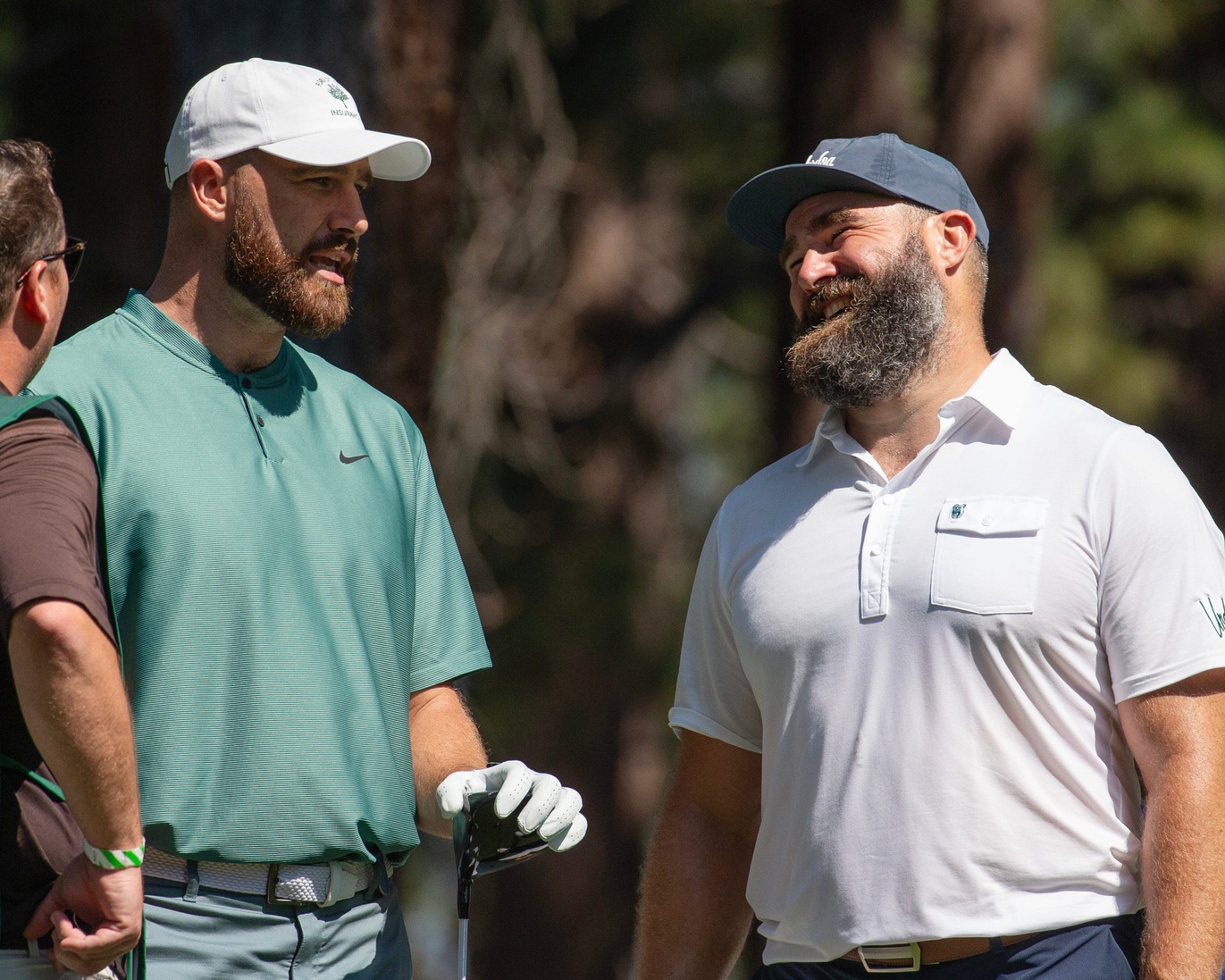 Travis Kelce and brother Jason Kelce talk on the 4th tee during the first round of the American Century Celebrity Championship golf tournament.