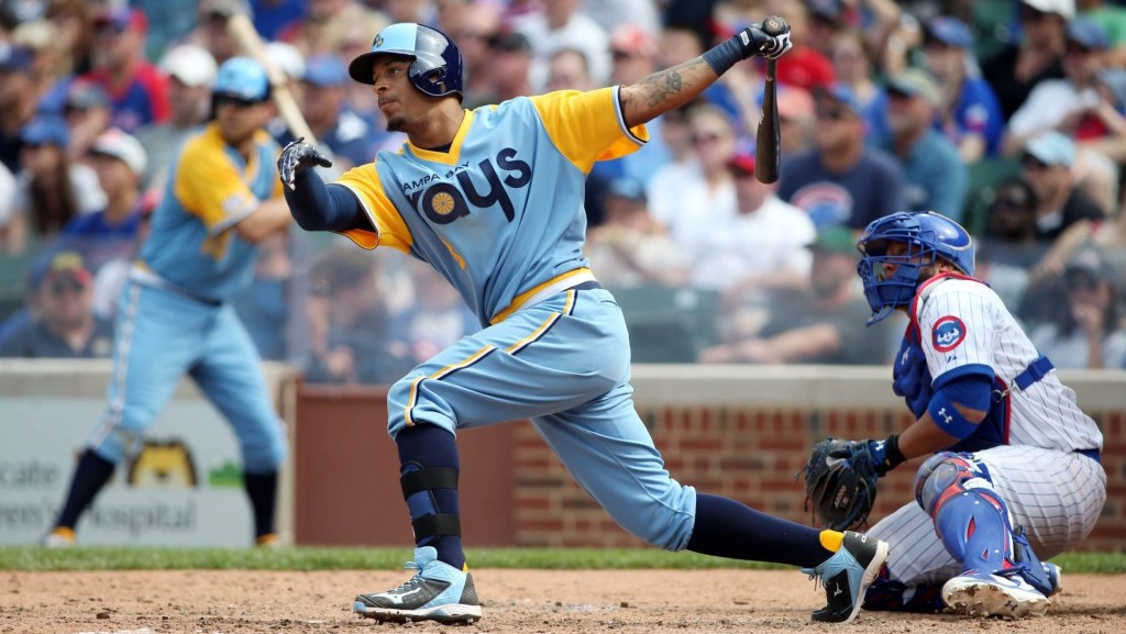 Aug 10, 2014; Chicago, IL, USA; Tampa Bay Rays center fielder Desmond Jennings hits a RBI double against the Chicago Cubs during the seventh inning at Wrigley Field