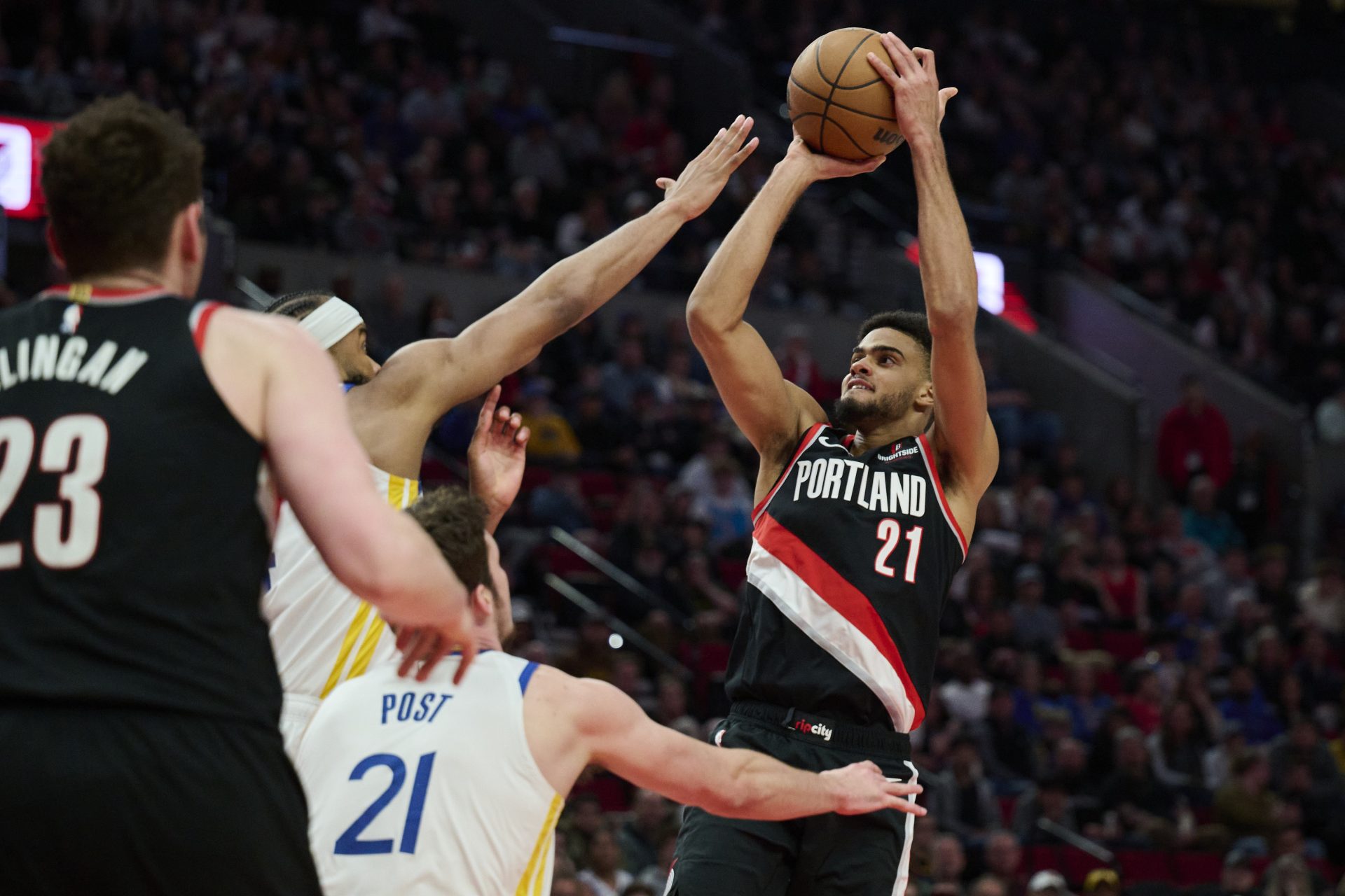 Apr 11, 2025; Portland, Oregon, USA; Portland Trail Blazers guard Rayan Rupert (21) shoots a jump shot during the second half against Golden State Warriors guard Moses Moody (4) at Moda Center.