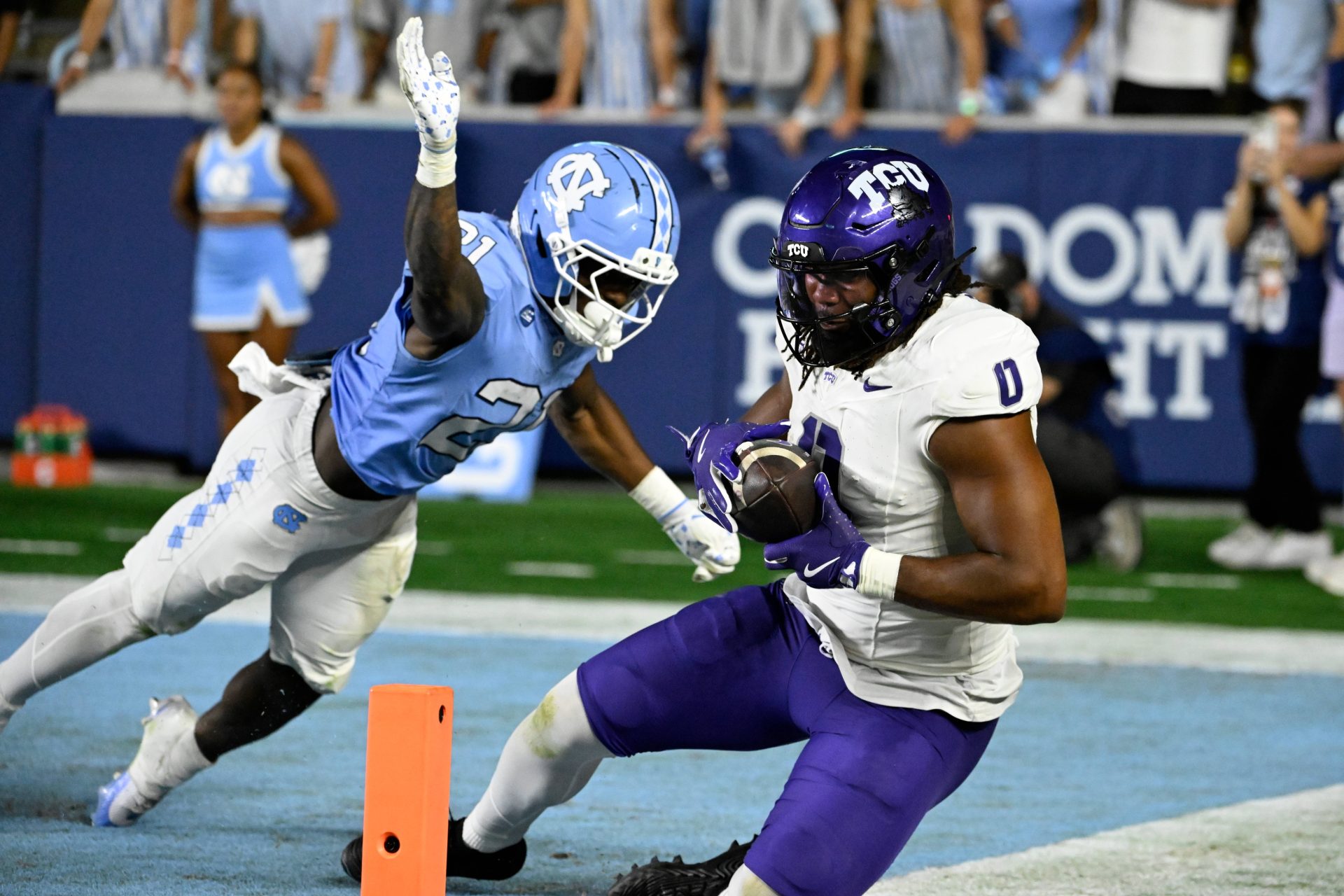 Sep 1, 2025; Chapel Hill, North Carolina, USA; TCU Horned Frogs tight end DJ Rogers (0) catches a touchdown pass as North Carolina Tar Heels defensive back Kaleb Cost (21) defends in the fourth quarter at Kenan Stadium.