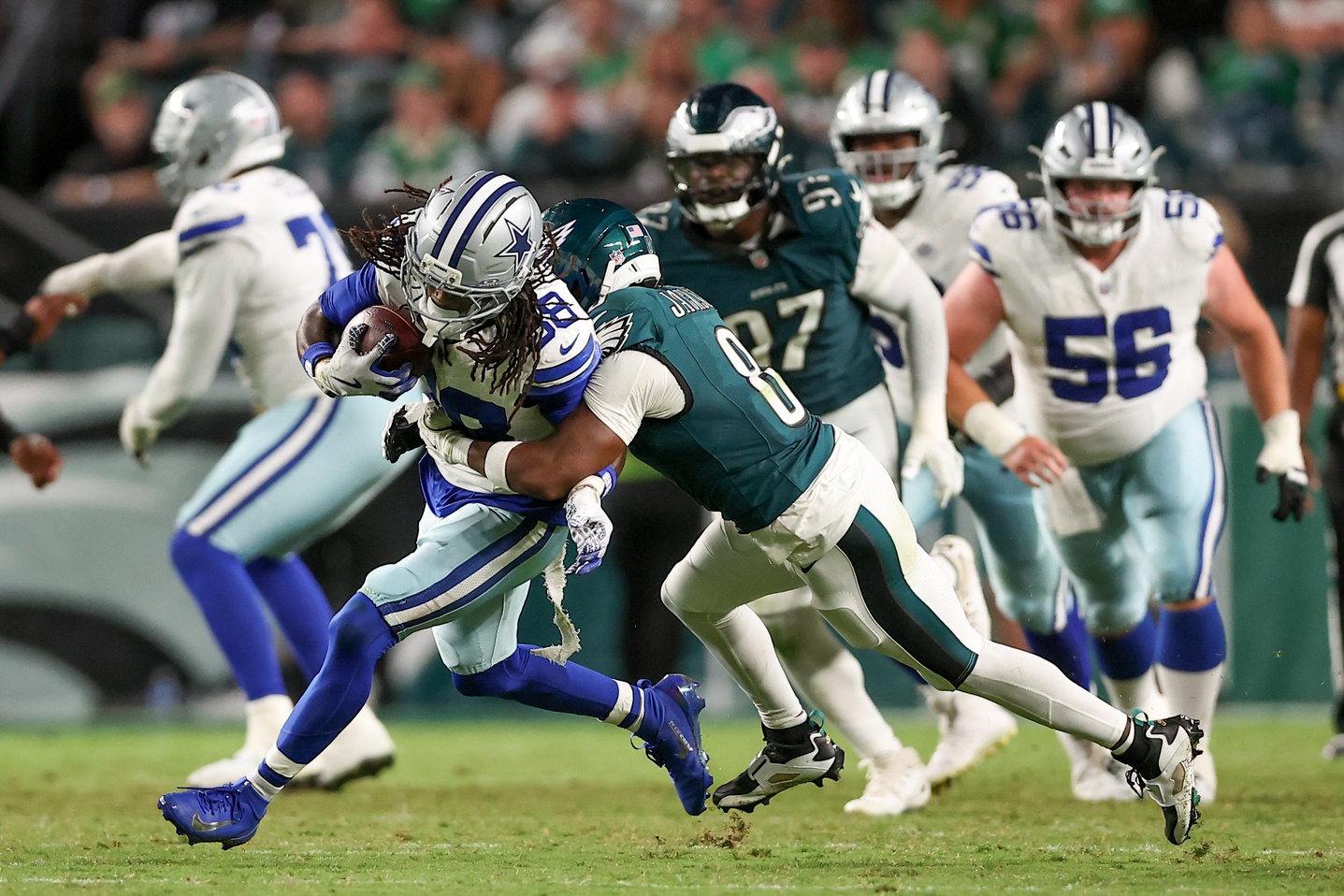 Sep 4, 2025; Philadelphia, Pennsylvania, USA; Philadelphia Eagles cornerback Adoree' Jackson (8) tackles Dallas Cowboys wide receiver CeeDee Lamb (88) during the third quarter of the game at Lincoln Financial Field.