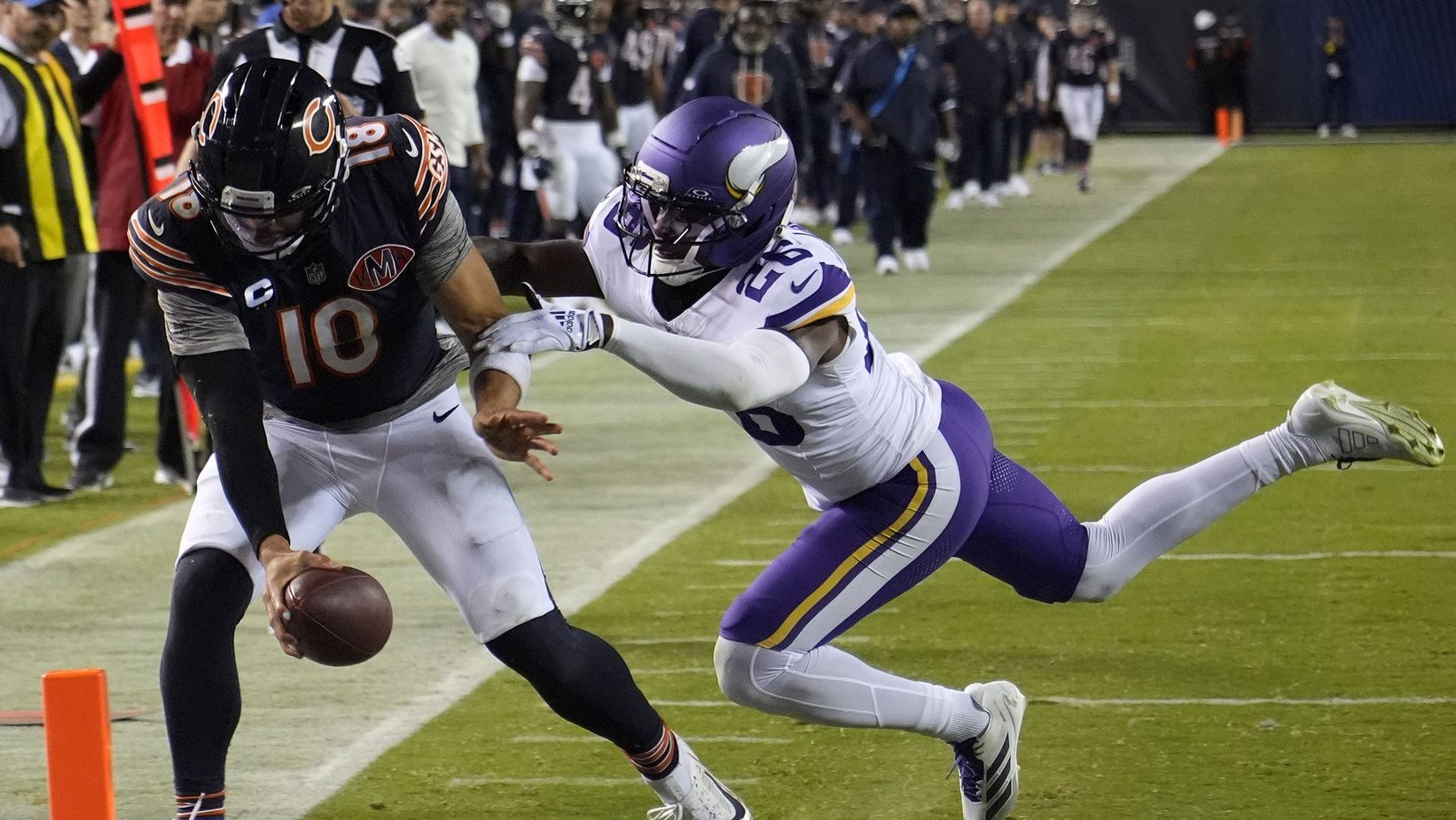 Sep 8, 2025; Chicago, Illinois, USA; Chicago Bears quarterback Caleb Williams (18) rushes the ball past Minnesota Vikings safety Theo Jackson (26) during the second half at Soldier Field.