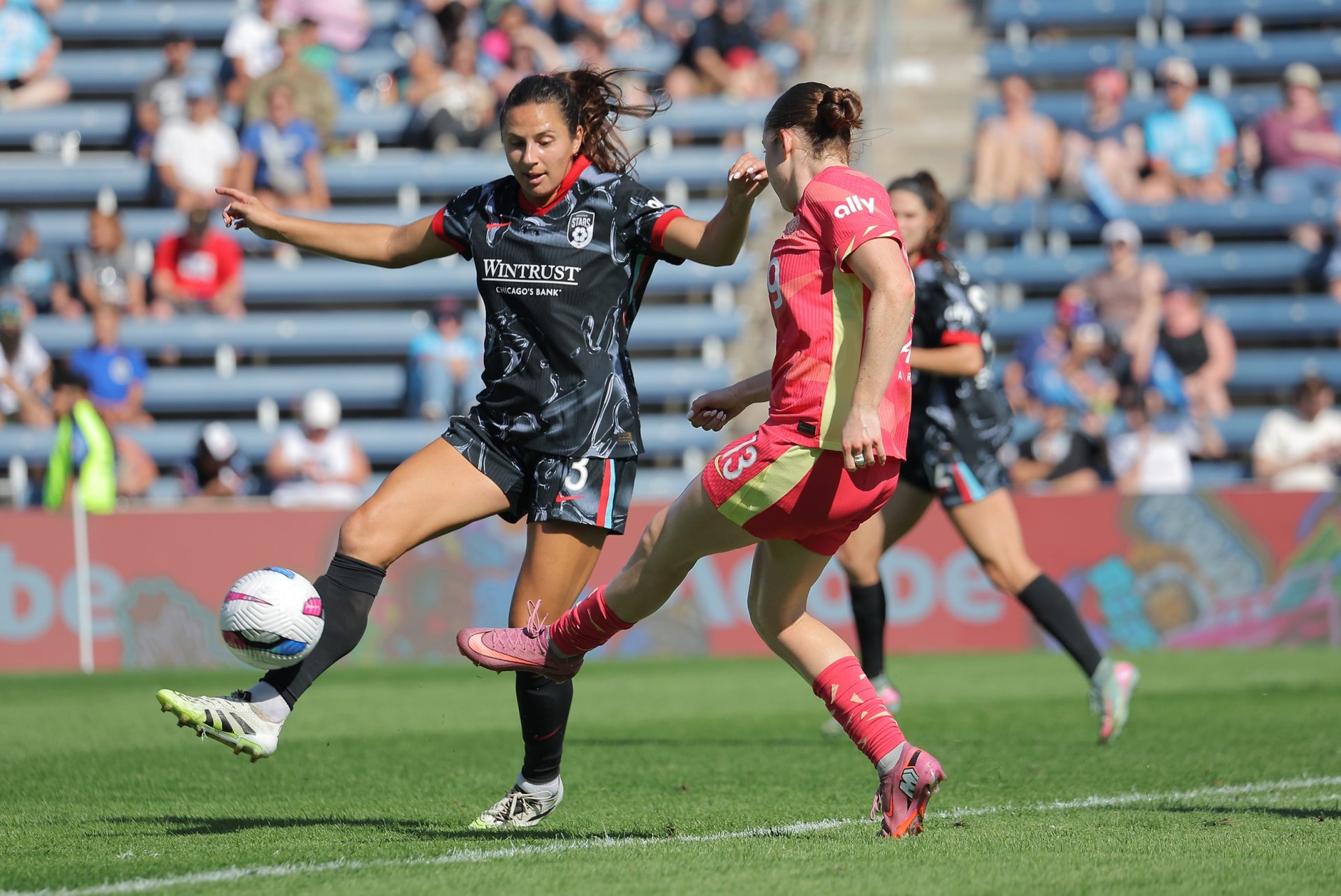 Sep 14, 2025; Bridgeview, Illinois, USA; Portland Thorns FC midfielder Olivia Moultrie (13) kicks the ball past Chicago Stars FC defender Sam Staab (3) during the second half of a match at SeatGeek Stadium.