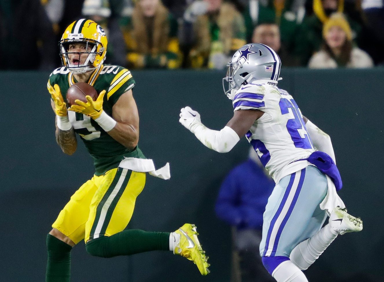 Green Bay Packers wide receiver Christian Watson (9) pulls down a touchdown reception against Dallas Cowboys cornerback DaRon Bland (26) in the fourth quarter during their football game Sunday, November 13, at Lambeau Field in Green Bay, Wis.