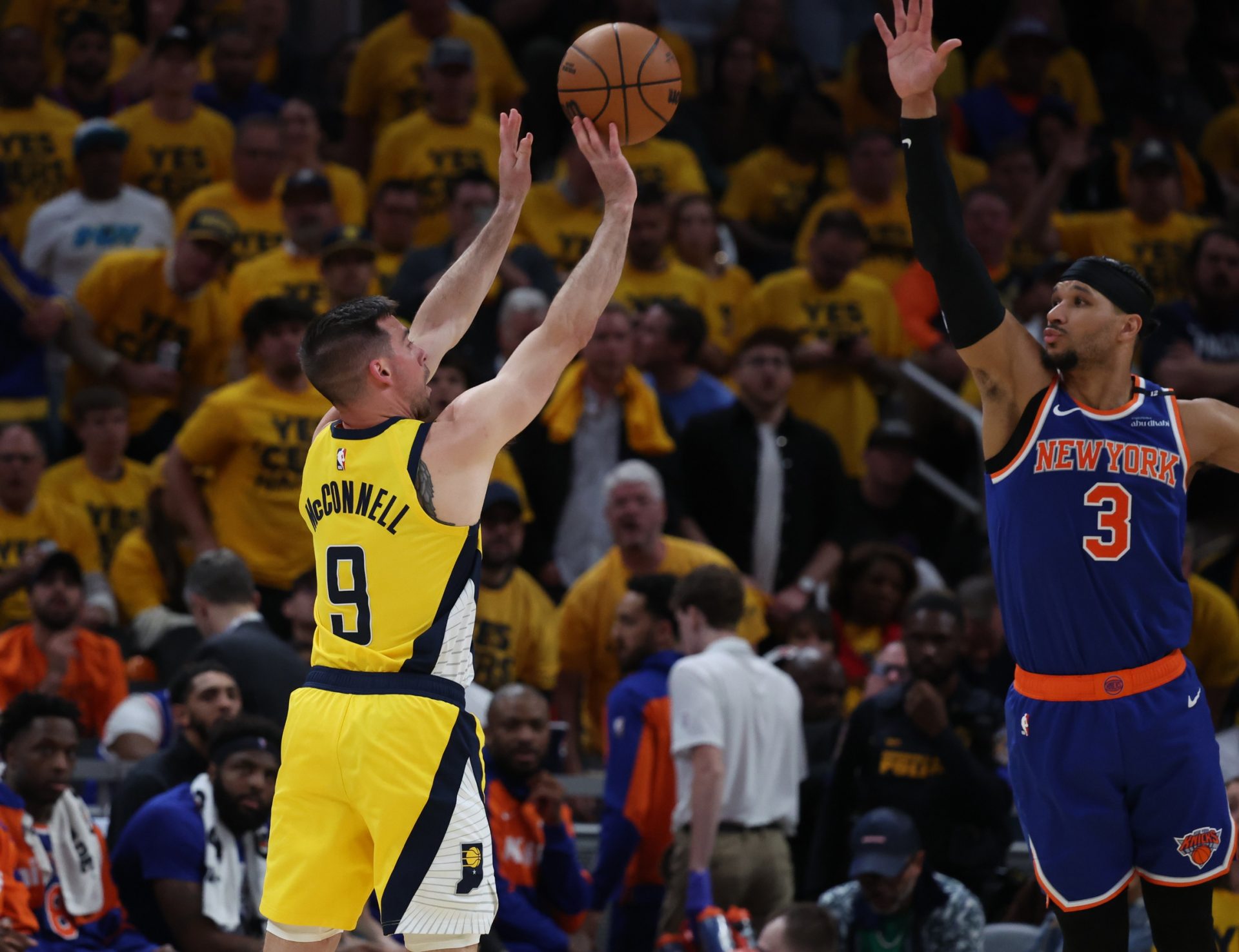 May 27, 2025; Indianapolis, Indiana, USA; Indiana Pacers guard T.J. McConnell (9) shoots a three point basket over New York Knicks guard Josh Hart (3) during the third quarter of game four of the eastern conference finals for the 2025 NBA Playoffs at Gainbridge Fieldhouse