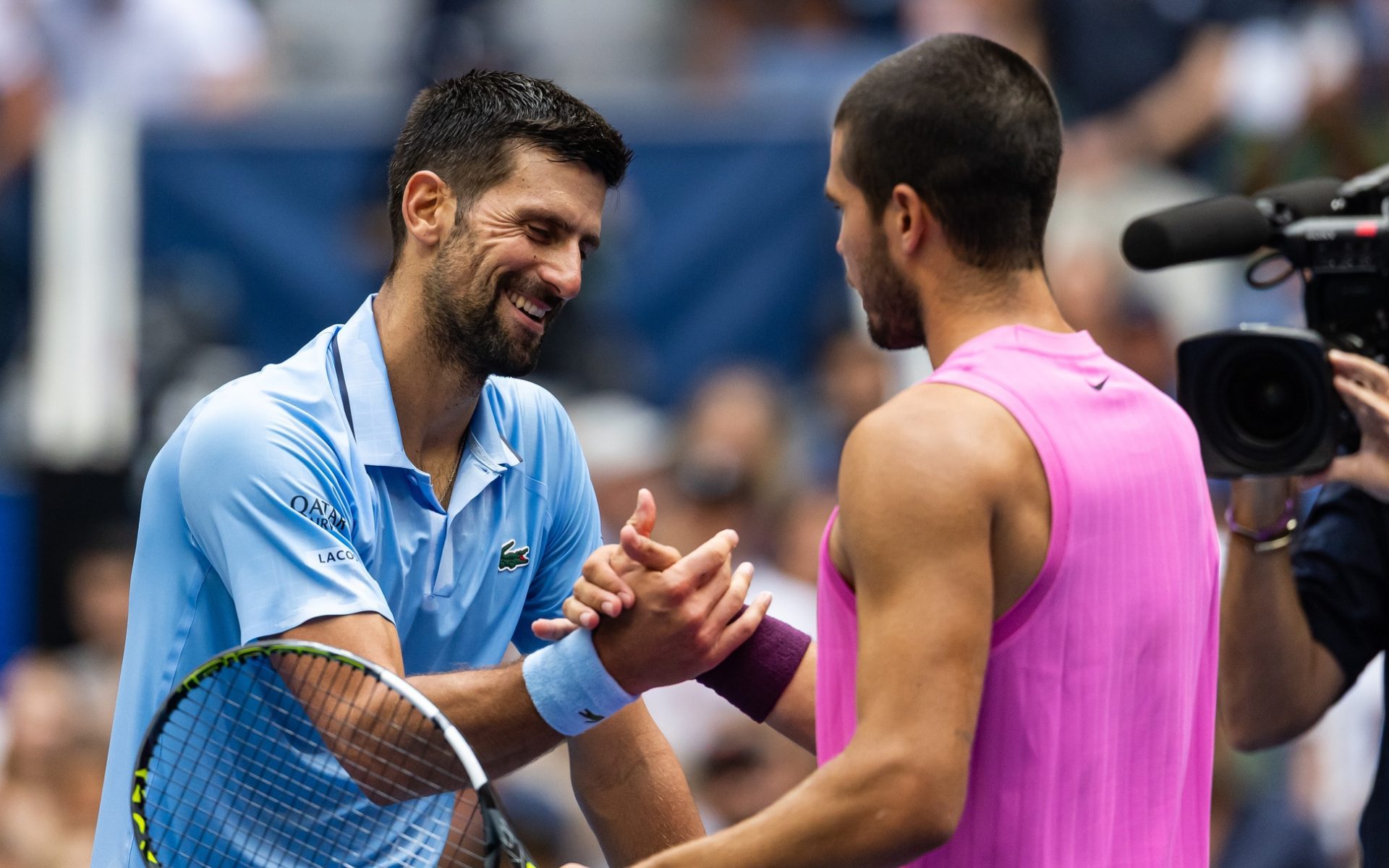 Sep 5, 2025; Flushing, NY, USA; Carlos Alcaraz of Spain and Novak Djokovic of Serbia embraces after their match in the semifinal of the mens singles at the US Open at Arthur Ashe Stadium in Billie Jean King National Tennis Center.