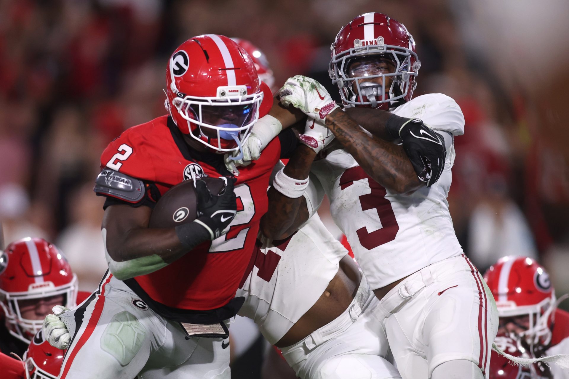 Sep 27, 2025; Athens, Georgia, USA; Georgia Bulldogs running back Josh McCray (2) runs against Alabama Crimson Tide linebacker Nikhai Hill-Green (41) and defensive back Keon Sabb (3) in the second half at Sanford Stadium.