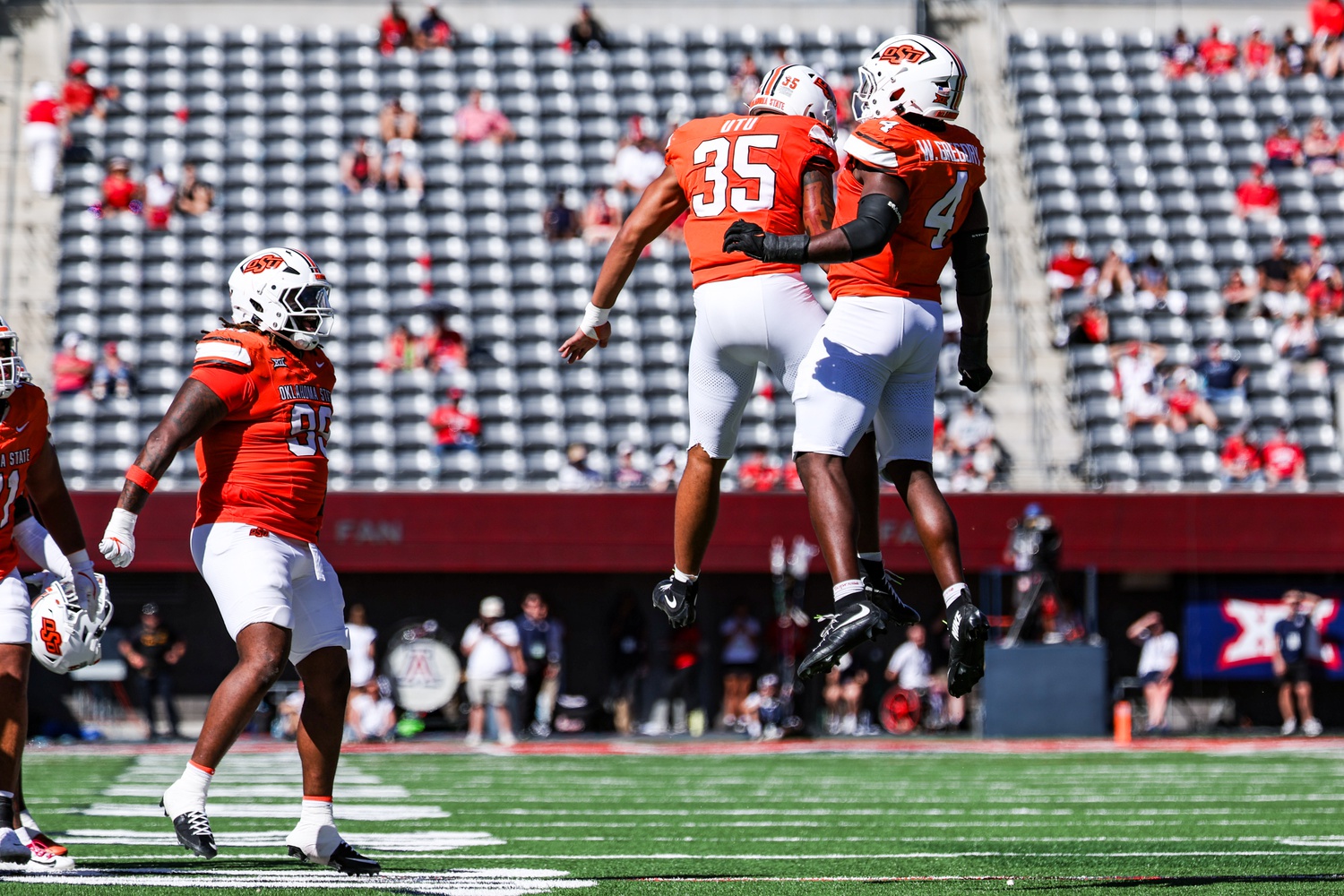 Oct 4, 2025; Tucson, Arizona, USA; Oklahoma State Cowboys outside linebacker Poasa Ute (35) and Wendell Gregory (4) celebrate during the third quarter of the game against the Arizona Wildcats at Arizona Stadium.