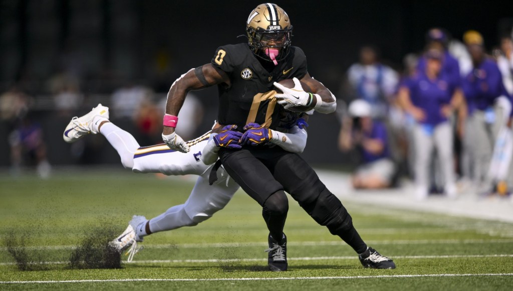 Oct 18, 2025; Nashville, Tennessee, USA; Vanderbilt Commodores wide receiver Junior Sherrill (0) drags Louisiana State Tigers cornerback Mansoor Delane (4) during the second half at FirstBank Stadium