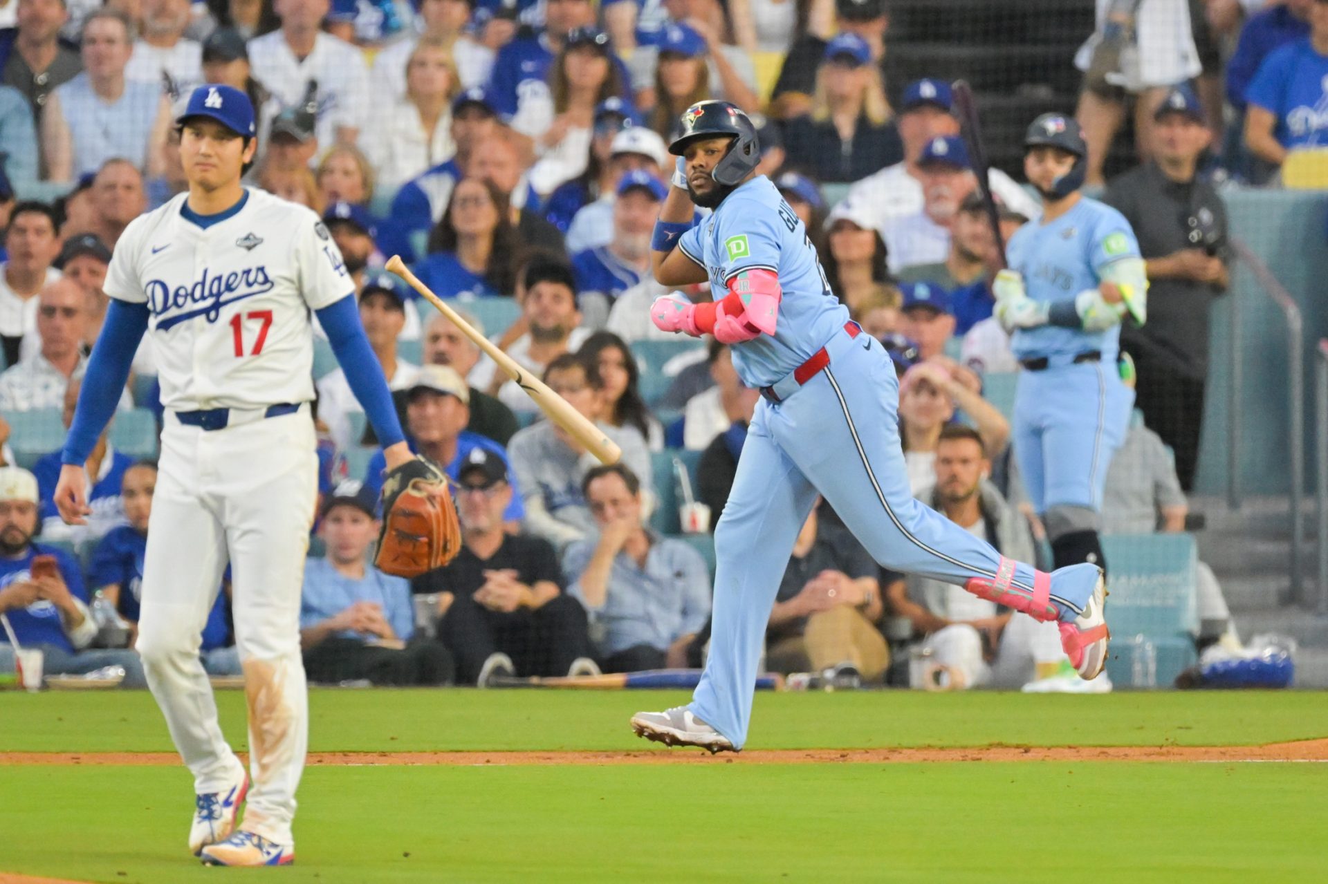 Oct 28, 2025; Los Angeles, California, USA; Toronto Blue Jays first baseman Vladimir Guerrero Jr. (27) throws his bat after hitting a two run home run as Los Angeles Dodgers two-way player Shohei Ohtani (17) looks on during the third inning of game four of the 2025 MLB World Series at Dodger Stadium.