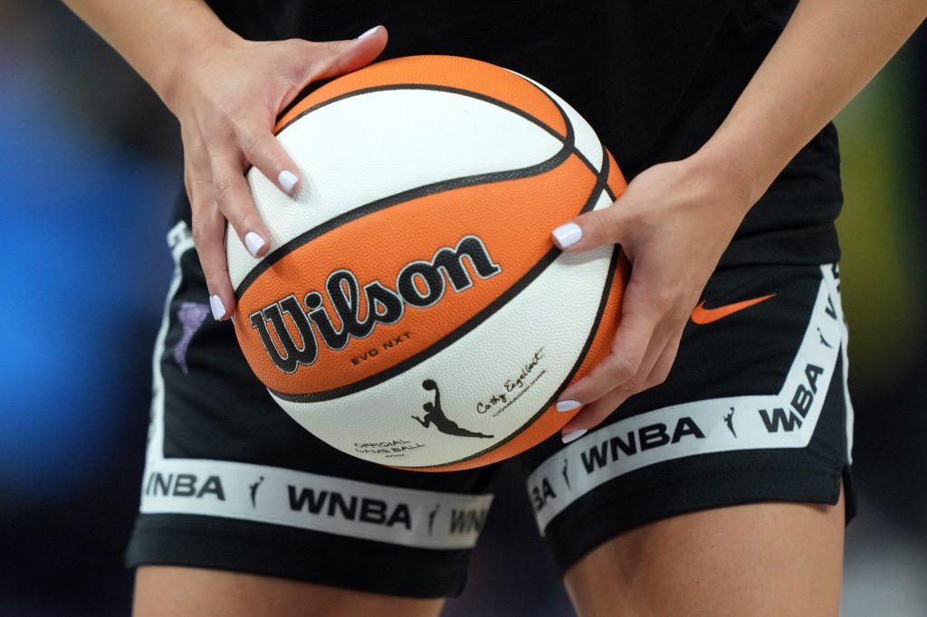 Aug 31, 2025; San Francisco, California, USA; Golden State Valkyries guard Kaitlyn Chen (2) holds a ball as the WNBA logo appears on the ball and shorts before the game against the Indiana Fever at Chase Center