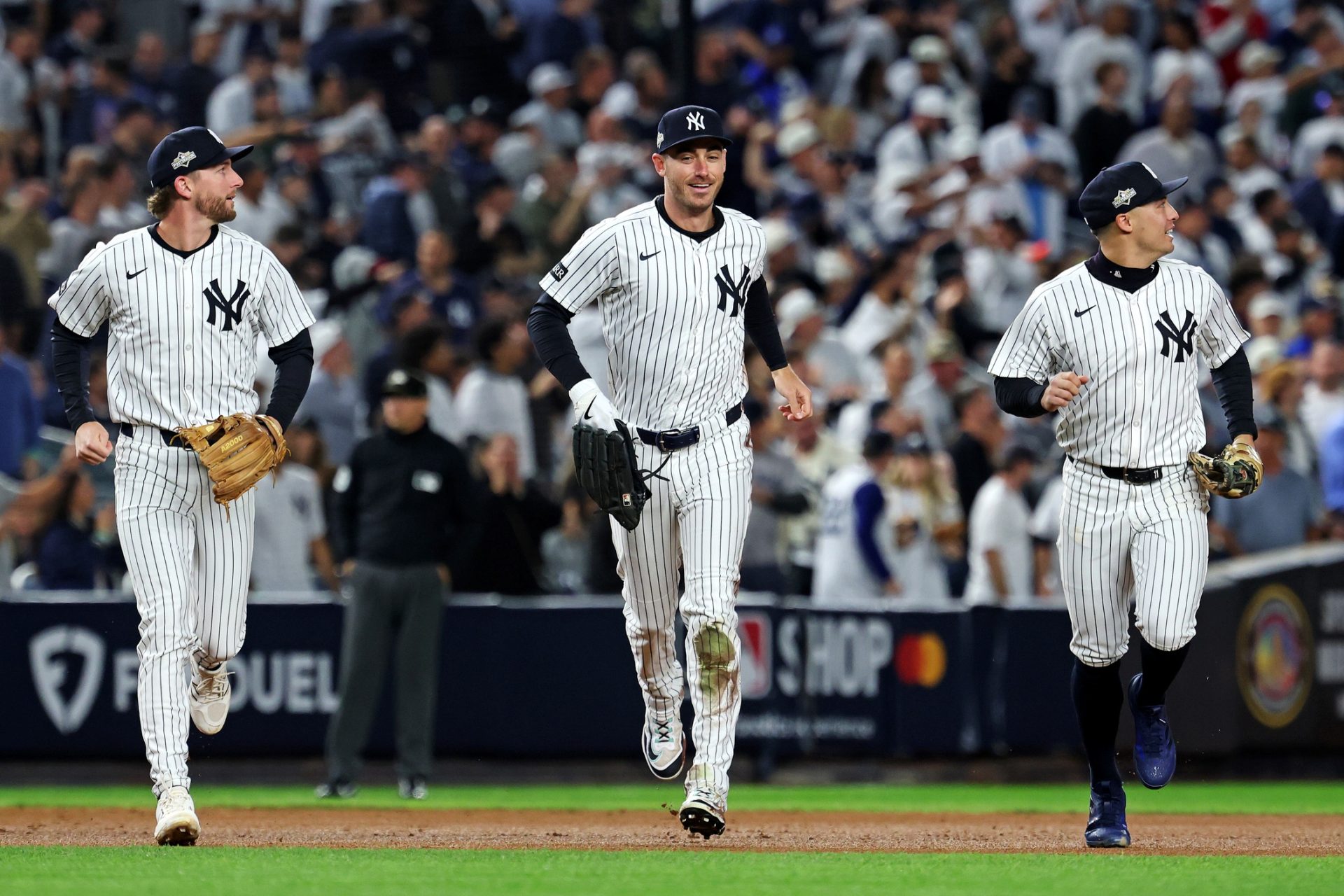 Oct 8, 2025; Bronx, New York, USA; New York Yankees left fielder Cody Bellinger (35) runs off the field after ending the first inning with a sliding catch against the Toronto Blue Jays during game four of the ALDS round for the 2025 MLB playoffs at Yankee Stadium.