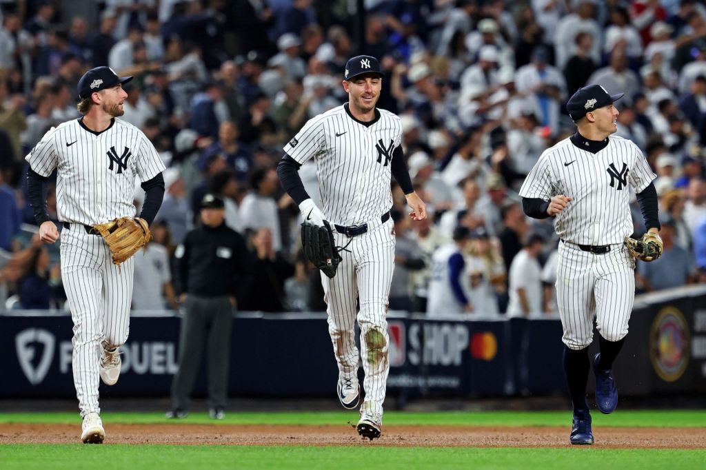 Oct 8, 2025; Bronx, New York, USA; New York Yankees left fielder Cody Bellinger (35) runs off the field after ending the first inning with a sliding catch against the Toronto Blue Jays during game four of the ALDS round for the 2025 MLB playoffs at Yankee Stadium.