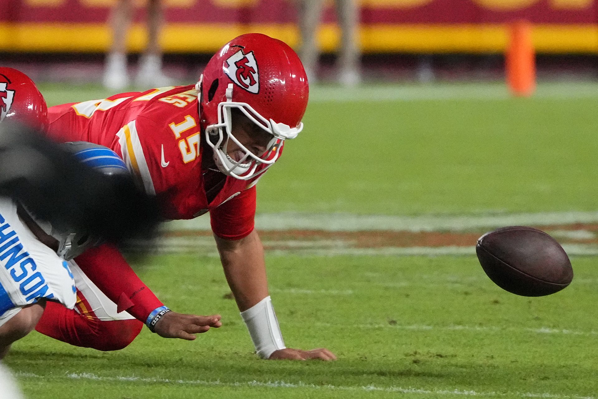 Oct 12, 2025; Kansas City, Missouri, USA; Kansas City Chiefs quarterback Patrick Mahomes (15) fumbles the ball against the Detroit Lions during the first half at GEHA Field at Arrowhead Stadium