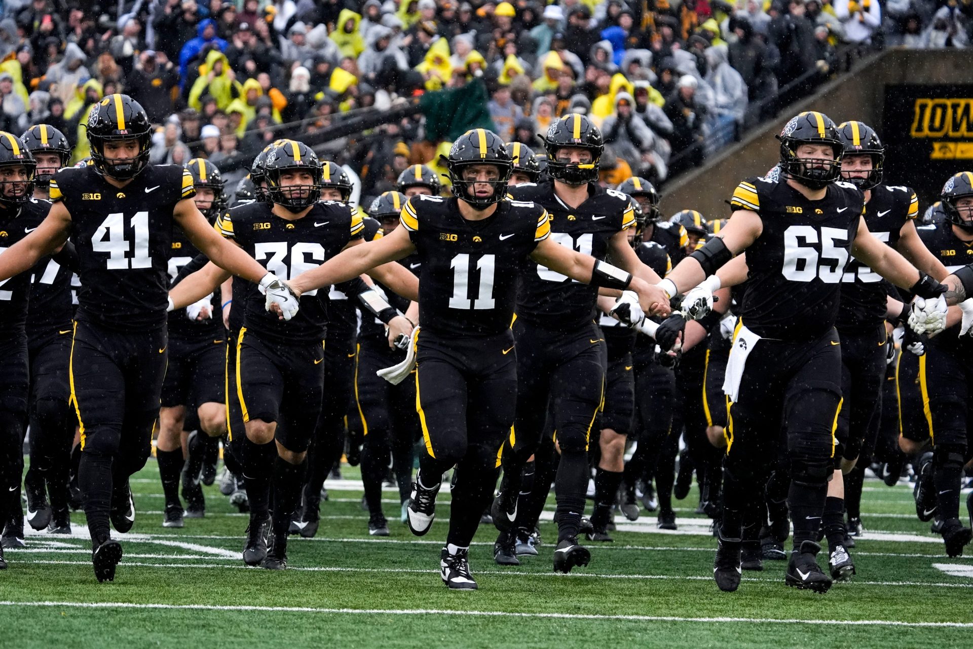 The Iowa Hawkeyes swarm onto the field Nov. 8, 2025 ahead of a Big Ten Football game against the Oregon Ducks at Kinnick Stadium in Iowa City, Iowa.