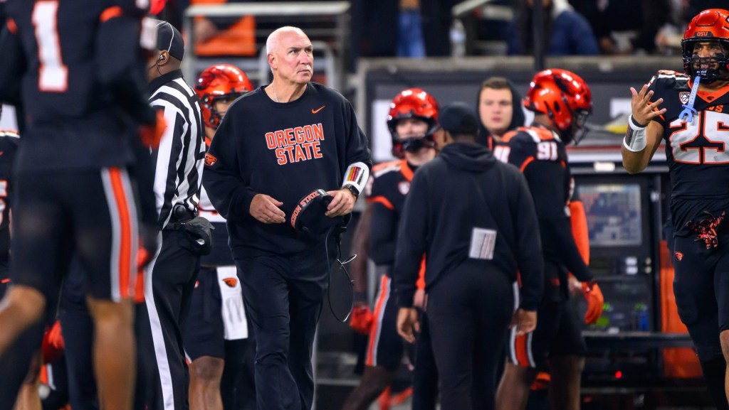 Nov 8, 2025; Corvallis, Oregon, USA; Oregon State Beavers interim head coach Robb Akey check the scoreboard during the second quarter against the Sam Houston Bearkats at Reser Stadium.