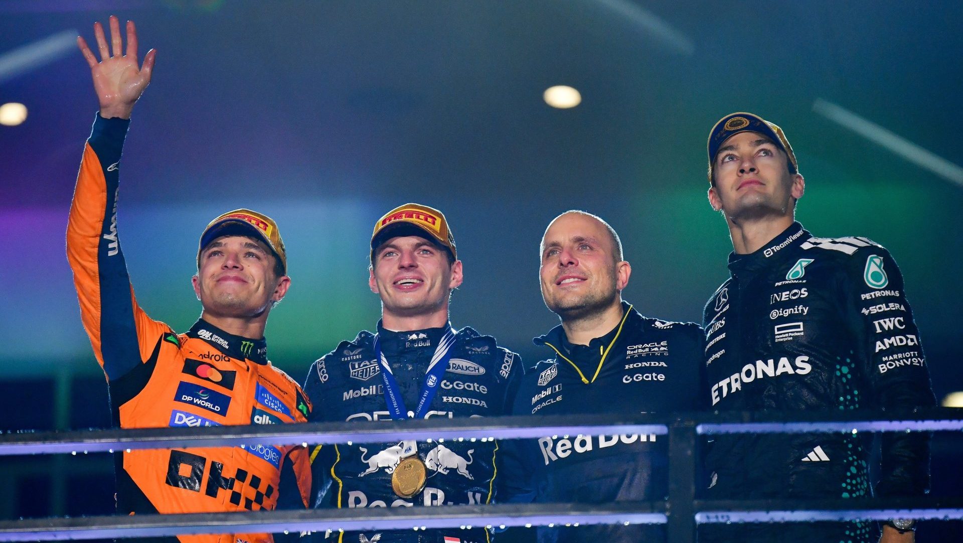 Nov 21, 2025; Las Vegas, NV, USA; McLaren driver Lando Norris (4) Red Bull Racing driver Max Verstappen (1) and Mercedes driver George Russell (63) pose for a photo with race engineer Gianpiero Lambiase following the Las Vegas Grand Prix at Las Vegas Strip Circuit.
