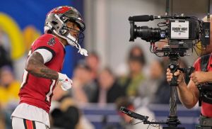 Nov 23, 2025; Inglewood, California, USA; Tampa Bay Buccaneers wide receiver Tez Johnson (15) poses for a television camera after scoring a touchdown against the Los Angeles Rams during the second quarter at SoFi Stadium.