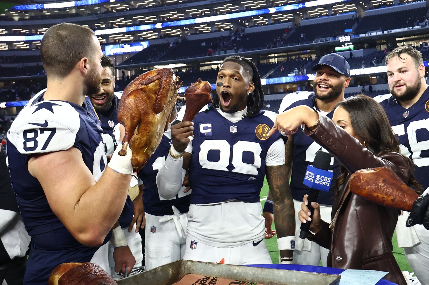 Nov 27, 2025; Arlington, Texas, USA; Dallas Cowboys tight end Jake Ferguson (87) and Dallas Cowboys wide receiver CeeDee Lamb (88) celebrate with a turkey after the game against the Kansas City Chiefs at AT&T Stadium.
