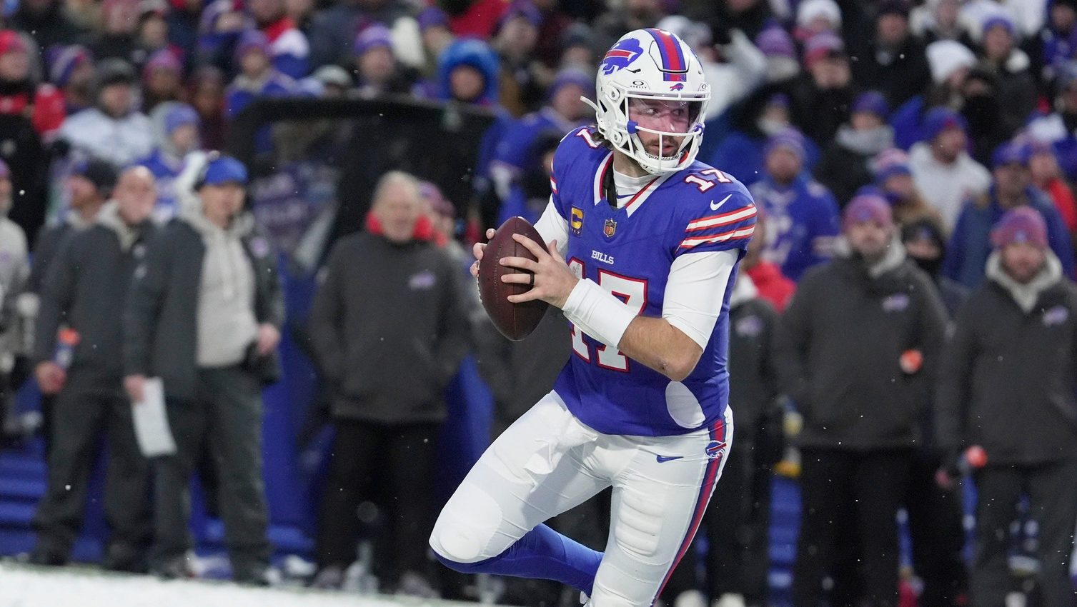 Buffalo Bills quarterback Josh Allen runs with the ball looking to throw to a receiver during second half action at Highmark Stadium in Orchard Park on Dec. 7, 2025