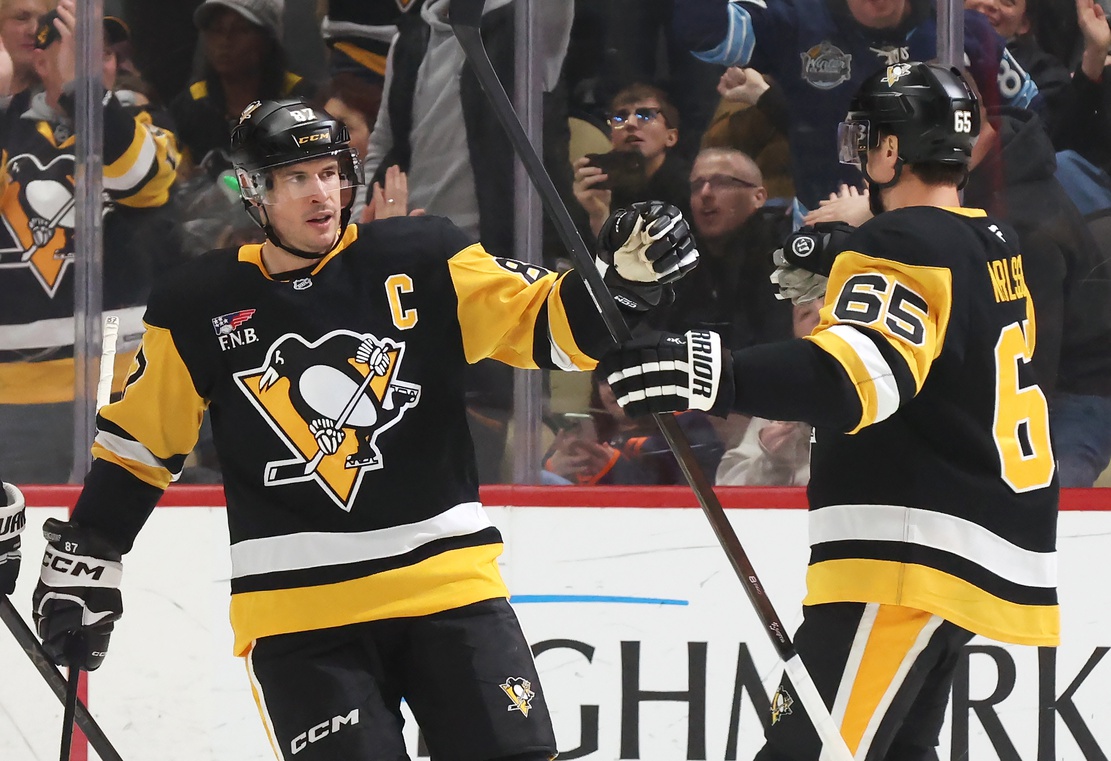 Dec 16, 2025; Pittsburgh, Pennsylvania, USA; Pittsburgh Penguins center Sidney Crosby (87) congratulates defenseman Erik Karlsson (65) on his goal against the Edmonton Oilers during the second period at PPG Paints Arena.