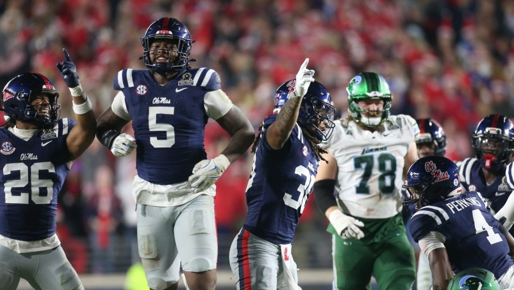Dec 20, 2025; Oxford, MS, USA; Mississippi Rebels linebacker Tahj Chambers (26), defensive end Kam Franklin (5) and linebacker Jaden Yates (30) reacts after a fumble recovery against the Tulane Green Wave during the second half of a game at Vaught-Hemingway Stadium.