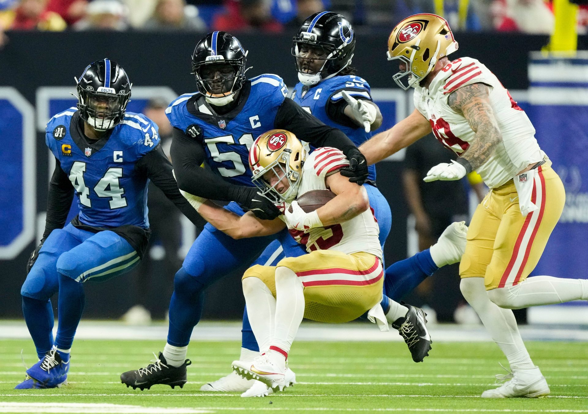 Indianapolis Colts defensive end Kwity Paye (51) tackles San Francisco 49ers running back Christian McCaffrey (23) on Monday, Dec. 22, 2025, during a game at Lucas Oil Stadium in Indianapolis.