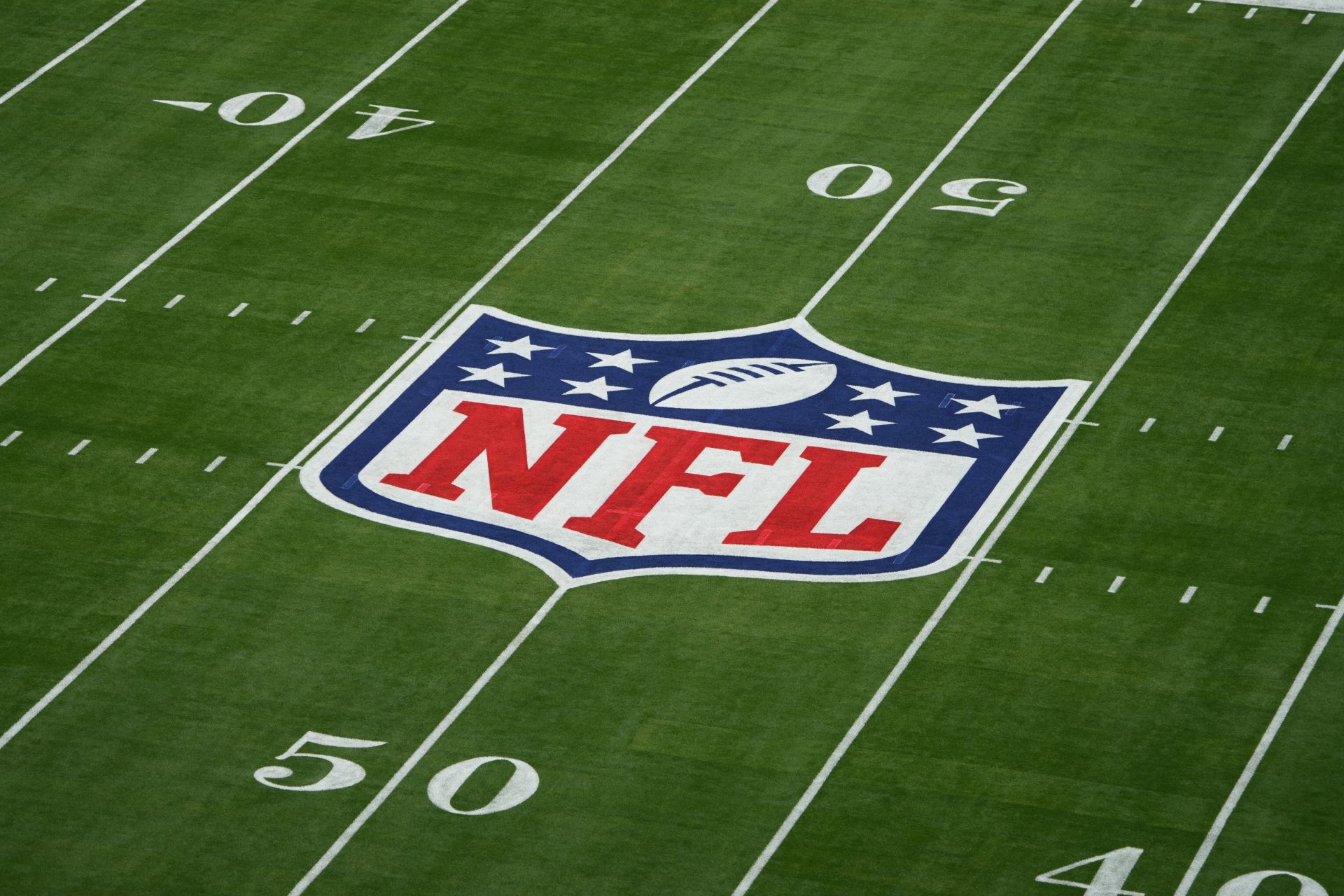 Feb 12, 2023; Glendale, AZ, USA; A general view of the NFL shield logo on the field before Super Bowl LVII between the Kansas City Chiefs and Philadelphia Eagles at State Farm Stadium.