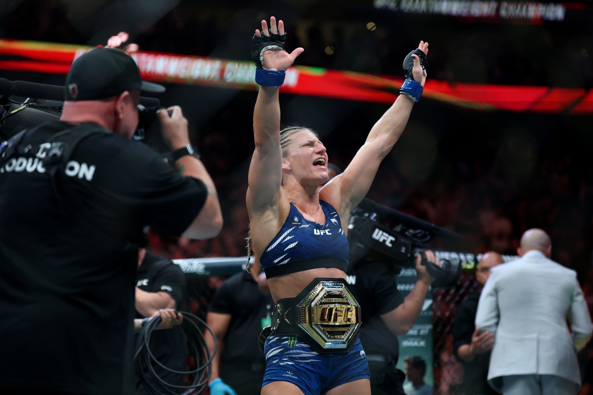 Jun 7, 2025; Newark, New Jersey, UNITED STATES; Kayla Harrison (blue gloves) reacts after defeating Julianna Pena (not pictured) in a bantamweight title bout during UFC 316 at Prudential Center.