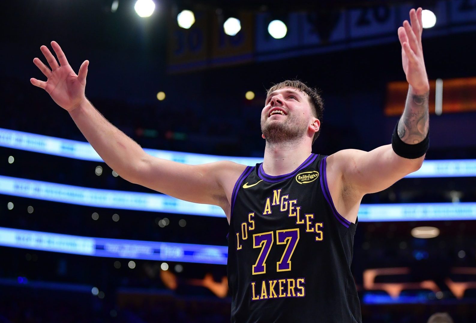 Dec 30, 2025; Los Angeles, California, USA; Los Angeles Lakers guard Luka Doncic (77) reacts after scoring a basket against the Detroit Pistons during the second half at Crypto.com Arena