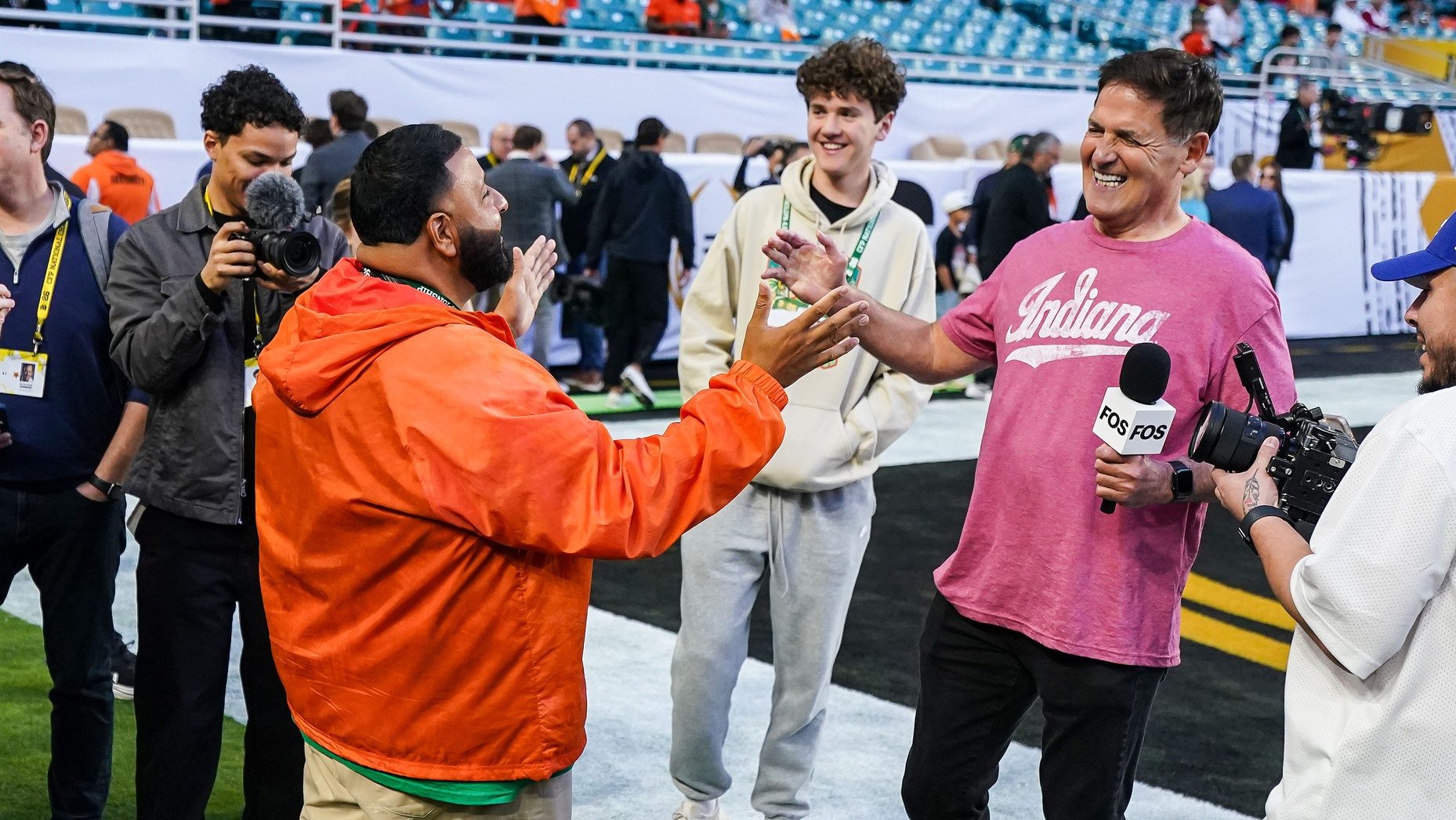 Mark Cuban shakes hands with D.J. Khaled on Monday, Jan. 19, 2026, ahead of the College Football Playoff Championship game at HardRock Stadium in Miami Gardens.