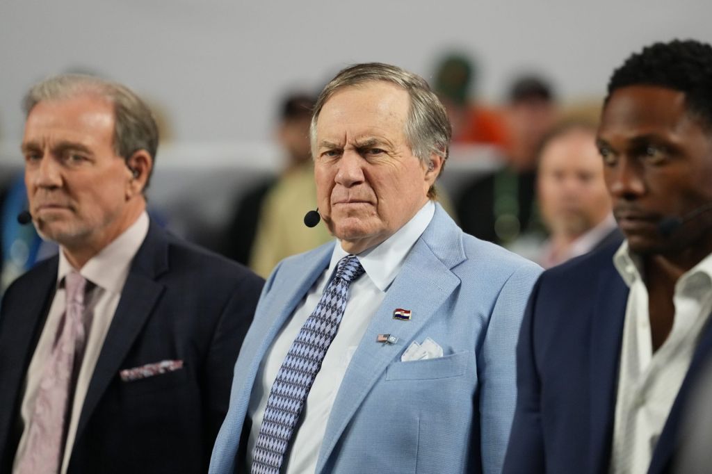 Jan 19, 2026; Miami Gardens, FL, USA; TV analyst Bill Belichick watches the Miami Hurricanes play the Indiana Hoosiers during the first half of the College Football Playoff National Championship game at Hard Rock Stadium.