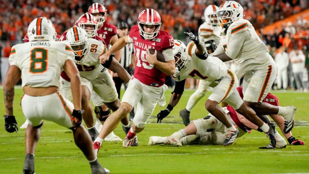 Indiana Hoosiers quarterback Fernando Mendoza (15) rushes into the end zone for a touchdown Monday, Jan. 19, 2026, during the College Football Playoff National Championship college football game against the Miami (FL) Hurricanes at Hard Rock Stadium in Miami Gardens.