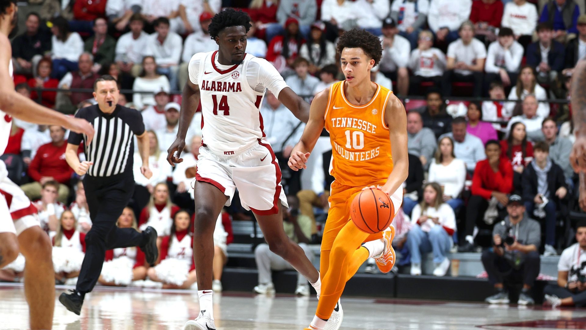 Jan 24, 2026; Tuscaloosa, Alabama, USA; Tennessee Volunteers forward Nate Ament (10) dribbles past Alabama Crimson Tide center Charles Bediako (14) during the first half at Coleman Coliseum.