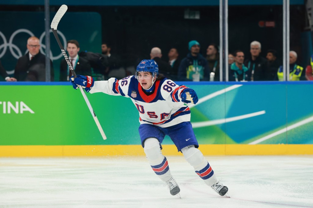 MILAN, ITALY - FEBRUARY 22: Jack Hughes #86 of Team United States celebrates scoring the game-winning goal in overtime during the Men's Gold Medal match between Canada and the United States on day 16 of the Milano Cortina 2026 Winter Olympic games at Milano Santagiulia Ice Hockey Arena on February 22, 2026 in Milan, Italy
